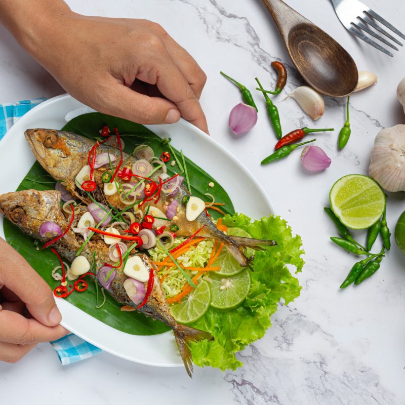 Hot and Spicy Mackerel Decorated with Thai food ingredients, World Food Day.