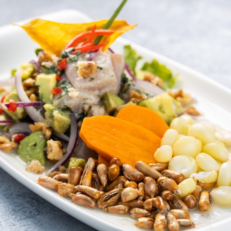 A closeup of a delicious salad with vegetables and herbs in a plate on the table